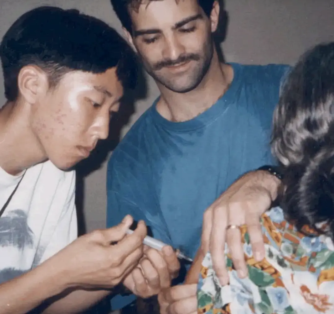 A medical team member giving an injection under supervision