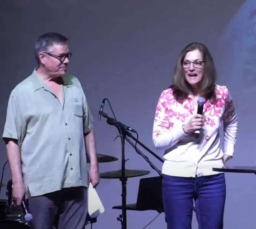 A woman speaking to a church congregation with a microphone