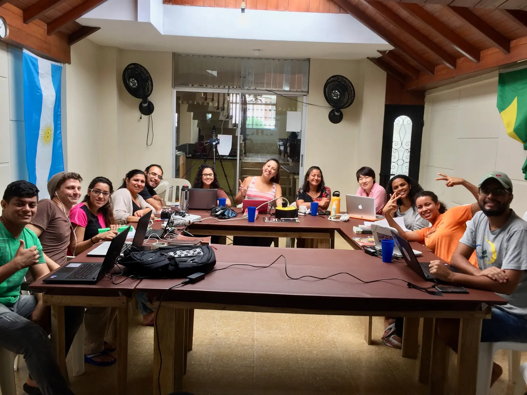 An international School of University Ministries class gathered around a table