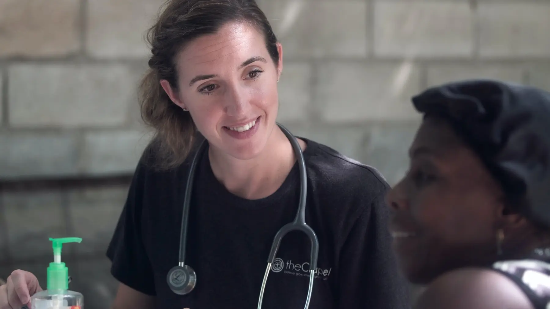 A medical professional speaking with a patient during an outreach