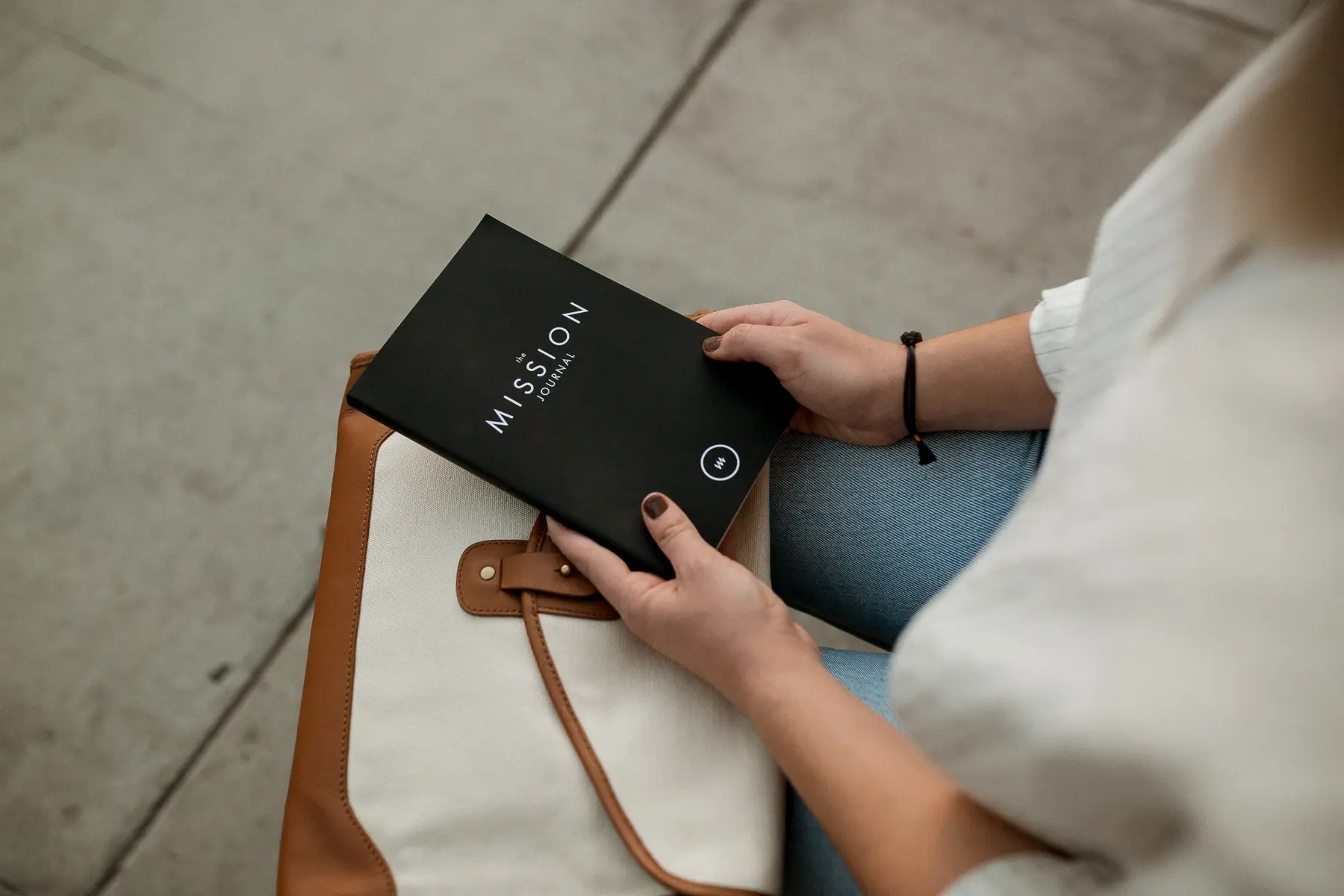 A person holding a mission journal