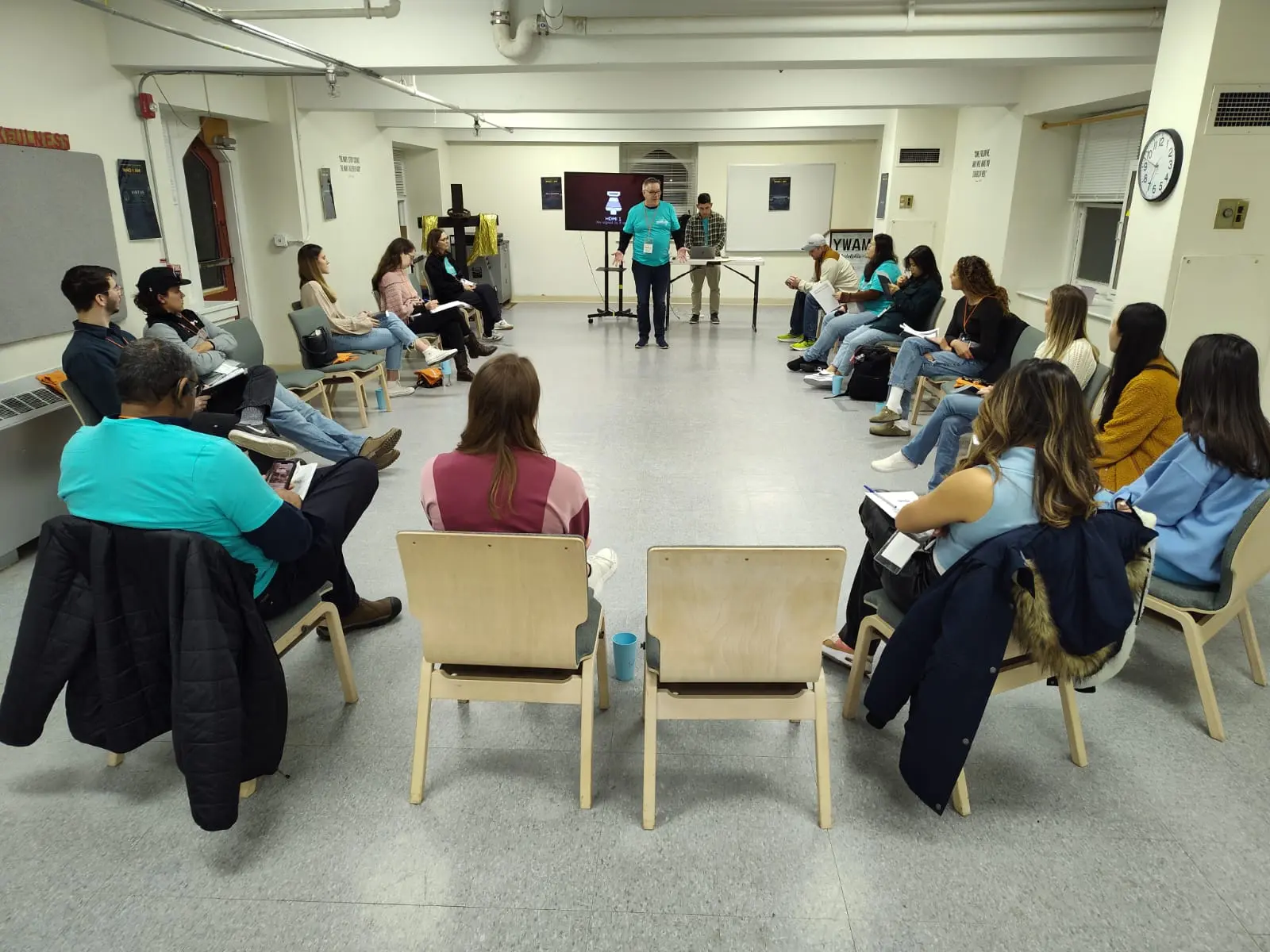 Young adults and facilitators seated in a large circle during a WHO I AM Intensive