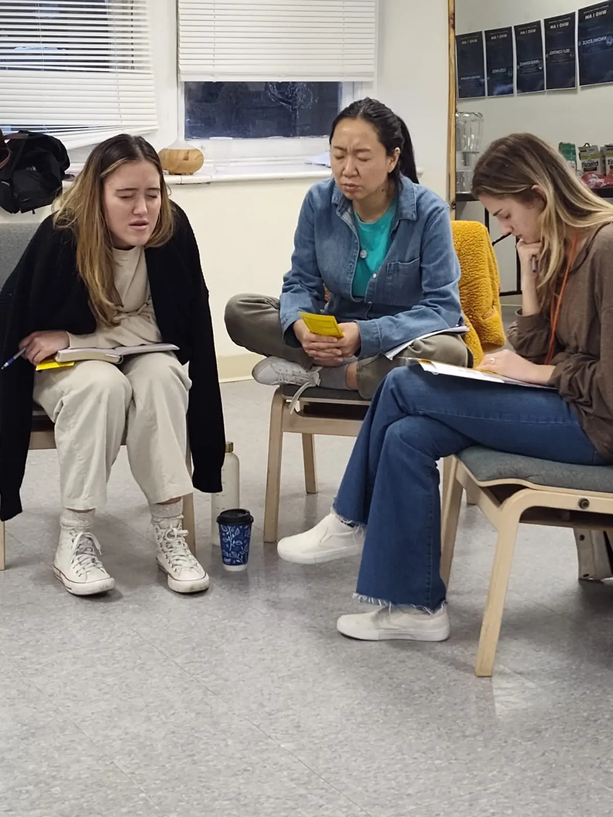 Three women praying and journaling together