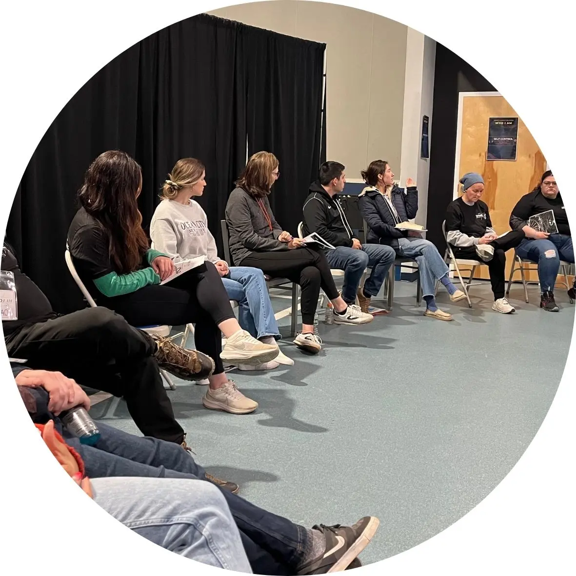 Participants listening and taking notes in a WHO I AM session