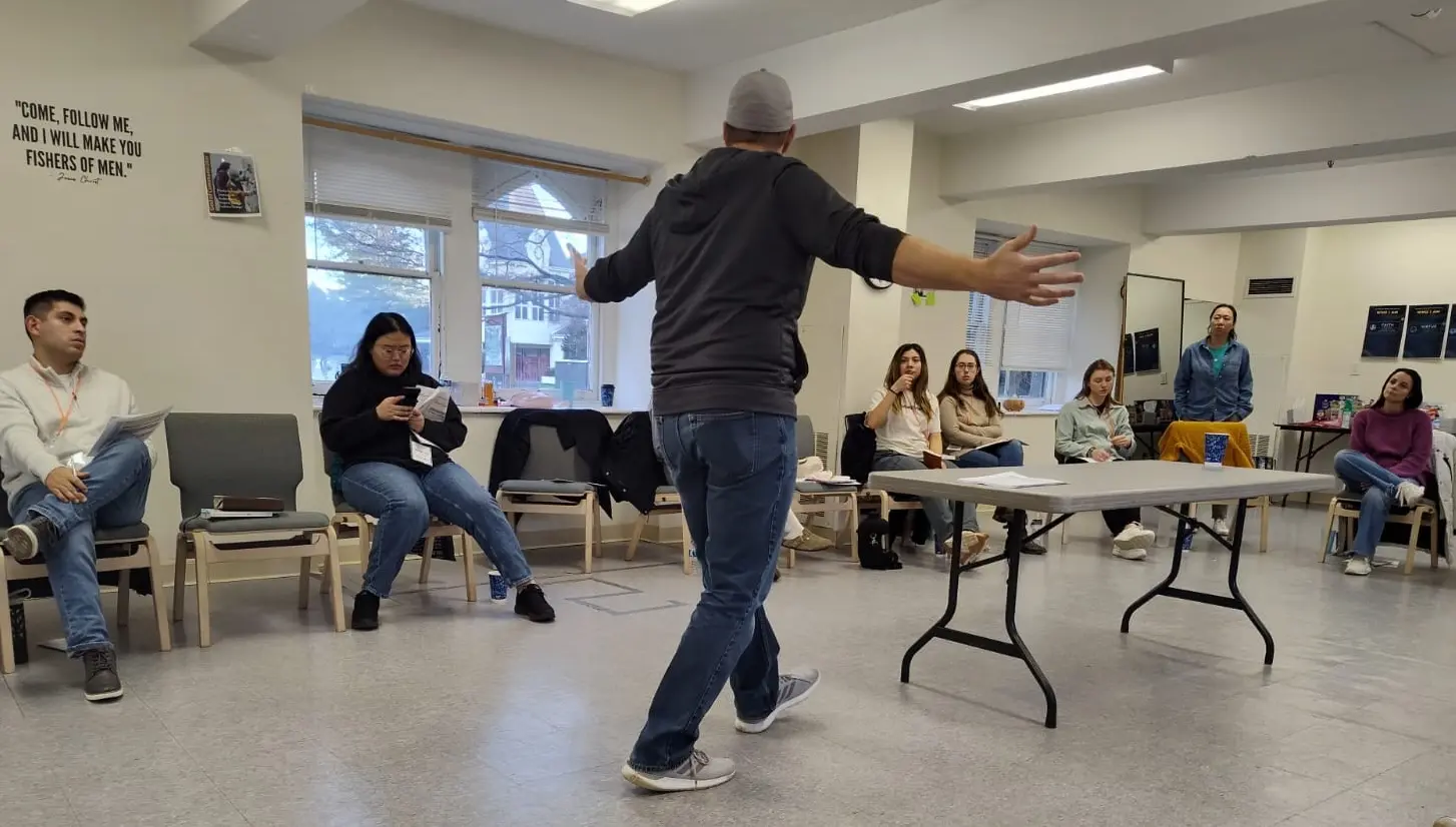 A facilitator teaching young adults during a WHO I AM Intensive