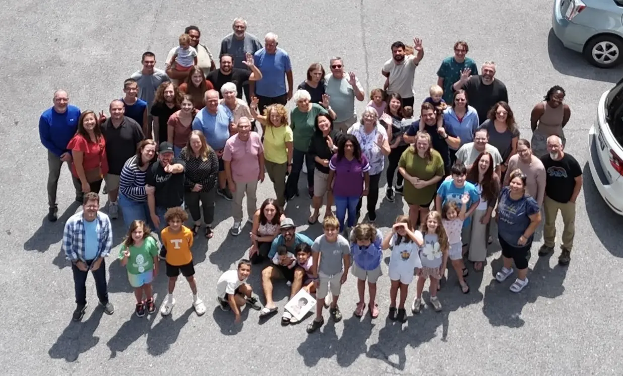 A multigenerational YWAM Converge satellite group gathered outdoors in Tennessee